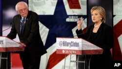 FILE - Hillary Clinton, right, makes a point as Bernie Sanders listens during a Democratic presidential primary debate in Des Moines, Iowa, Nov. 15, 2015. 