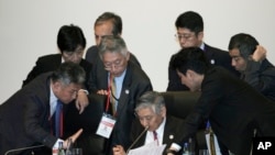 Bank of Japan Governor Haruhiko Kuroda, center bottom, speak with other participants prior to G20 Finance Ministers' and Central Bank Governors' Meeting Saturday, June 8, 2019, in Fukuoka, western Japan.