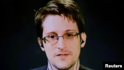 FILE - Edward Snowden delivers remarks via video link from Moscow to attendees at a discussion regarding an International Treaty on the Right to Privacy, Protection Against Improper Surveillance and Protection of Whistleblowers in Manhattan, New York, Sept. 24, 2015.