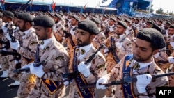 FILE - Members of Iran's Revolutionary Guards Corps (IRGC) march during the annual military parade marking the anniversary of the outbreak of the devastating 1980-1988 war with Saddam Hussein's Iraq, in the capital Tehran, Sept. 22, 2018. More than a dozen Iranian security forces were kidnapped in a pre-dawn raid in southeastern Sistan-Baluchistan province.