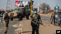 Soldiers patrol outside a shopping mall in Vosloorus, east of in Johannesburg, South Africa, July 14, 2021.