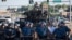Riot police stand guard as demonstrators protest the shooting death of teenager Michael Brown in Ferguson, Missouri, Aug. 13, 2014. 