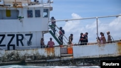 U.S. Coast Guard Cutter Harriet Lane boarding team alongside Vanuatu Fishery Department and Police Maritime Wing officers start a fishery boarding on a fishing vessel in the Vanuatu Exclusive Economic Zone in the South Pacific Ocean, Feb. 26, 2024. 
