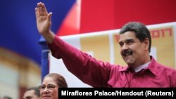 Venezuela's President Nicolas Maduro waves as he arrives for a rally with supporters in Caracas, Venezuela, Nov. 7, 2017. 