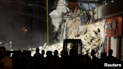 Volunteers dig through the rubble of buildings that collapsed in the explosion at the city's port area, after signs of life were detected, in Gemmayze, Beirut, Lebanon, Sept. 5, 2020.