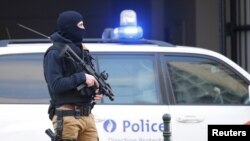 FILE - A Belgian special forces police officer stands guard outside a courthouse, Brussels, Belgium, April 7, 2016. 