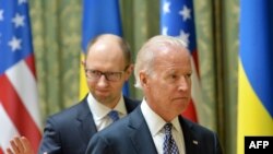 US Vice President Joe Biden (R) and Ukraine's acting Prime Minister Arseniy Yatsenyuk leave after a joint press conference in Kyiv on April 22, 2014. 