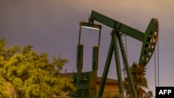 Pump jacks draw crude oil from the Long Beach Oil Field in Signal Hill, Calif., on March 9, 2020. U.S. crude oil rose 24% April 2, 2020, after President Donald Trump said he spoke to the Russian and Saudi leaders about production cuts.