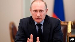 Russian President Vladimir Putin speaks at a Security Council meeting at the Kremlin in Moscow, Russia, March 28, 2014.