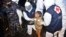 FILE - Medical workers help a Rohingya young girl upon arrival at Krueng Geukueh Port in North Aceh, Indonesia, Dec. 31, 2021.