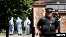 Police officers and forensic officers are pictured near the scene of reported multiple stabbings in Reading, Britain, June 22, 2020. 