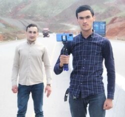 Fazliddin Mehmonov, holding his phone, and his colleague Akmal Eshonkhonov are shown in this photo from the Telegram messaging app. (Effect.uz)