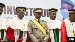New interim Malian President, Colonel Assimi Goita, center, stands with members of the Supreme Court during his swearing in ceremony in Bamako on June 7, 2021.