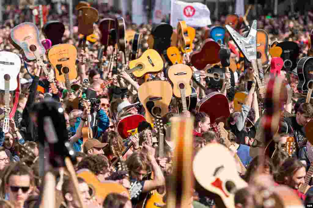 A mass gathering of guitarists attempt to beat the Guinness record for ensemble guitar playing in Wroclaw, Poland.&nbsp;According to media reports 7,356 musicians gathered in Wroclaw Market Square to play Jimi Hendrix&#39;s hit &#39;Hey Joe&#39;.