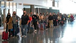 Air travelers line up to go through a security checkpoint at Salt Lake City International Airport in Salt Lake City, Utah, Nov. 25, 2020.