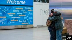 FILE - Abdullah Alghazali, right, hugs his 13-year-old son, Ali Abdullah Alghazali, after the Yemeni boy stepped out of an arrival entrance at John F. Kennedy International Airport in New York, Feb. 5, 2017.