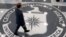 FILE - A man crosses the Central Intelligence Agency (CIA) logo in the lobby of CIA Headquarters in Langley, Virginia.
