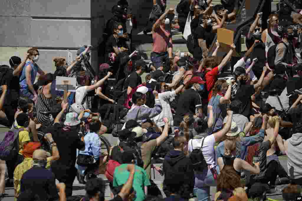 Watu, wengine wakiwa wamepiga magoti wamekusanyika Uwanja wa Trafalgar Square katikati ya mji wa London Jumamosi, Mei 31, 2020.