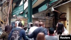 Onlookers view a New Jersey Transit train that derailed and crashed through the station in Hoboken, New Jersey, in this picture courtesy of Chris Lantero, taken Sept. 29, 2016. 
