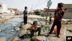 រូបភាព​ឯកសារ៖ ក្មេង​ប្រុស​ជនជាតិ​អ៊ីរ៉ាក់ ផឹក​ទឹក​ពី​ទុយោ​ដែល​បែក​មួយ​ក្នុង​ទីក្រុង​ Sadr នៃ​ទីក្រុង​បាកដាដ ប្រទេស​អ៊ីរ៉ាក់។