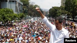 FILE - Venezuelan opposition leader Juan Guaido gestures as he speaks to supporters during a rally against the government of President Maduro and to commemorate May Day in Caracas, May 1, 2019.