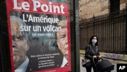 The front page of French weekly newspaper Le Point displays a photo of President Donald Trump and Democratic presidential candidate former Vice President Joe Biden with a headline reading "America on a volcano, (and Us too)" in Paris, Wednesday Sept. 30, 