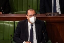 Tunisian Prime Minister Hichem Michichi attends the presentation of his new ministers before the Tunisian Assembly headquarters in the capital Tunis, Jan. 26, 2021.