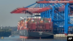 FILE - A container ship is loaded at the harbor in Hamburg, Germany, Oct. 15, 2018.