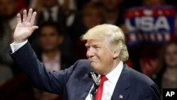 President-elect Donald Trump waves and smiles as he speaks during the first stop of his post-election tour, Dec. 1, 2016, in Cincinnati, Ohio. 