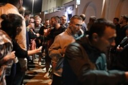 Relatives and friends greet people after being released from a detention center where protesters were detained during a mass rally following the presidential election in Minsk, Belarus, Aug. 14, 2020.