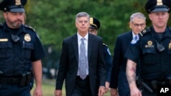 Ambassador William Taylor, is escorted by U.S. Capitol Police as he arrives to testify before House committees as part of the Democrats' impeachment investigation of President Donald Trump, at the Capitol in Washington, Oct. 22, 2019. 