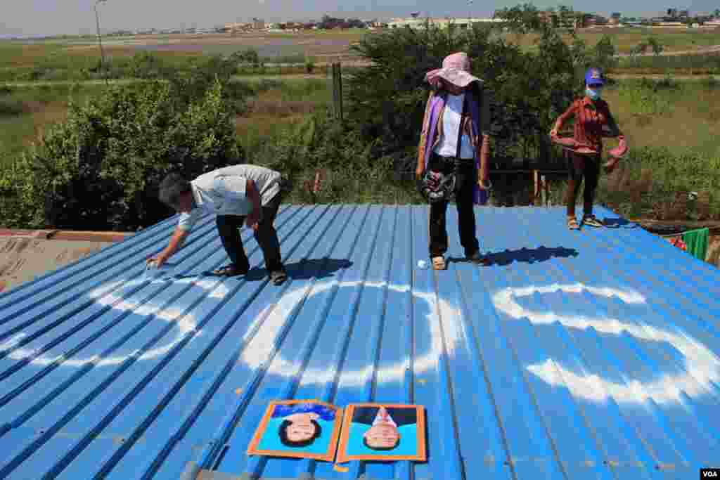 A tourist takes pictures of Buddha statues at a temple in Colombo, Sri Lanka.