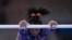 Simone Biles, of United States performs on the uneven bars during the women's artistic gymnastic qualifications at the 2020 Summer Olympics, July 25, 2021, in Tokyo. 