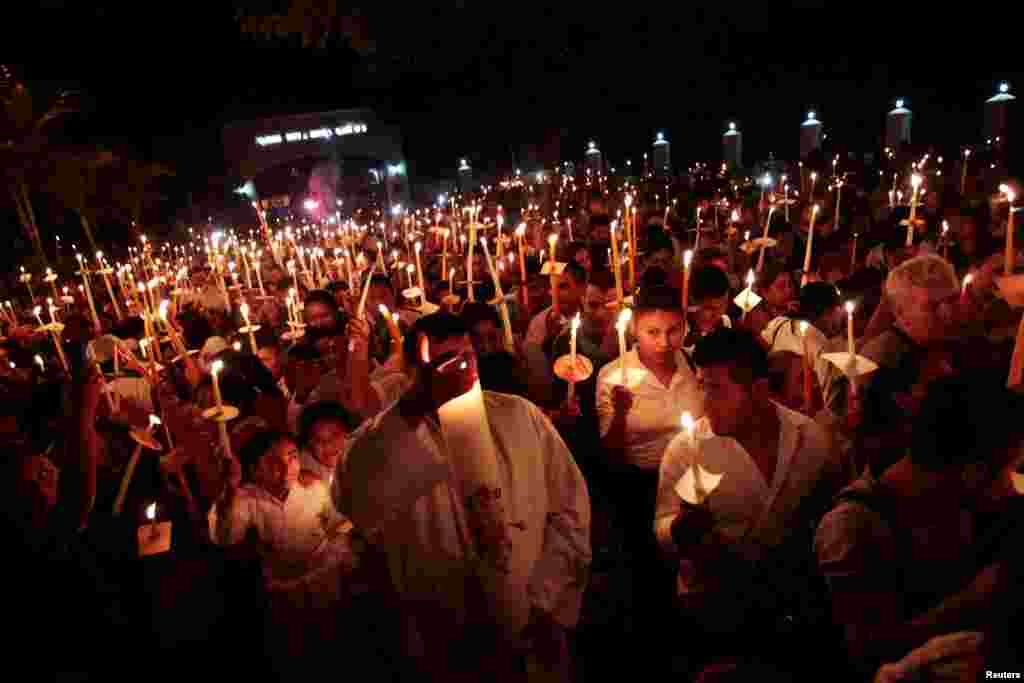Catholics take part in the Procession of Lights, as part of the Holy Week celebration in Nahuizalco, El Salvador, April 15, 2017. 