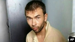 This image released by the Royal Thai Police shows a man who was arrested at an apartment on Aug. 29, 2015, in Bangkok, Thailand, along with evidence police said included bomb-making equipment.