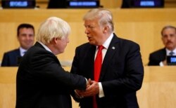 FILE - U.S. President Donald Trump shakes hands with Boris Johnson, left, then the British foreign secretary, as they take part in a session on reforming the United Nations at U.N. Headquarters in New York, Sept. 18, 2017.