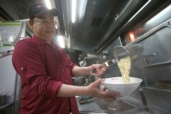 Chef Hung cooks pineapple beef noodle at his restaurant in Taipei, Taiwan, March 10, 2021.
