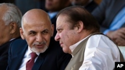 阿富汗总统加尼与巴基斯坦总理谢里夫2014年11月15日在伊斯兰堡观看一场板球赛时交谈