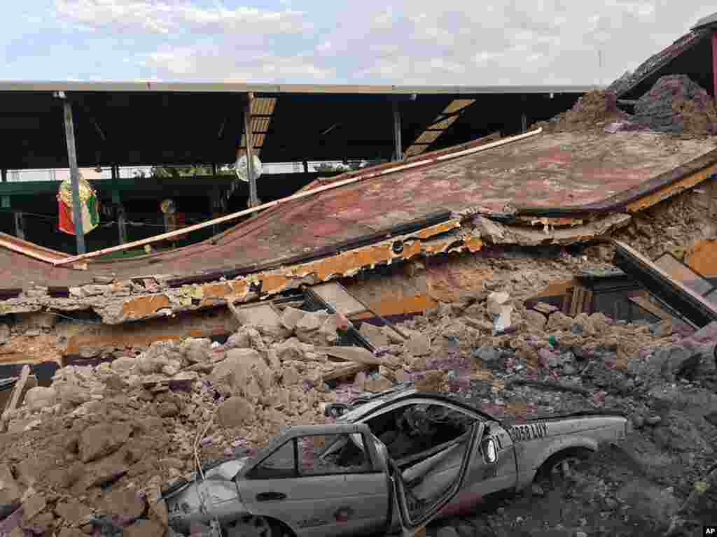 A car is crushed in a pile of rubble from a collapsed building by a 7.1-magnitude earthquake, in Jojutla, Morelos state, Mexico, Sept. 19, 2017.