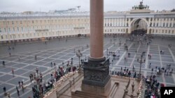 People gather to honor 224 victims killed in Saturday's plane crash over Egypt, at the foot of the Alexander Column at Dvortsovaya Square in St. Petersburg, Russia, Nov. 4, 2015.