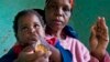 HIV positive child, Gift is given some jam prior to her ARV medication by a carer Tuesday Nov. 30, 2010 near Durban South Africa. (AP Photo/John Robinson)
