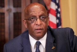 FILE - Baltimore Mayor Bernard "Jack" Young speaks to a supporter following a news conference announcing a new collaboration in an effort to reduce homelessness in Baltimore, July 2, 2019 file photo.