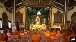 រូបឯកសារ៖ ព្រះសង្ឃអង្គុយដោយរក្សាគម្លាតពីគ្នាដោយមានពាក់ម៉ាស់ដើម្បីការពារការឆ្លងជំងឺកូវីដ១៩ សូត្រធម្មទេសនាក្នុងវត្តមួយកន្លែង នៅរាជធានីភ្នំពេញ កាលពីថ្ងៃទី ២៣ ខែមីនា ឆ្នាំ ២០២០។