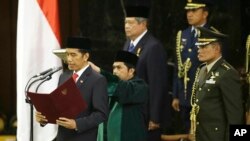 President Indonesia ke tujuh, Joko Widodo, membacakan sumpah di gedung DPR/MPR RI, Jakarta (20/10). (AP/Dita Alangkara)