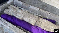 In this Jan. 4, 2021 photo released by Mexico's National Institute of Anthropology, known by its Spanish acronym INAH, the statue of a female figure unearthed in Hidalgo Amajac, is seen in nearby Alamo Temapache, Veracruz state, Mexico. 