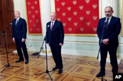 FILE - Russian President Vladimir Putin, center, Azerbaijan's President Ilham Aliyev, left, and Armenian Prime Minister Nikol Pashinyan speak to media after talks in Kremlin in Moscow, Russia, Jan. 11, 2021.