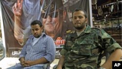 Motasin Younis, left, and Mohammed Hamed Younis, right, son and nepheiw of Libyan rebels' slain military chief Abdel-Fattah Younis seen during a interview in rebel-held Benghazi, Libya, Aug. 1, 2011