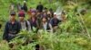 Montagnard hill tribesmen walk towards the main road after emerging from dense forest 70 km (43 miles) northeast of Ban Lung, located in Cambodia's northeastern province of Ratanakiri July 22, 2004. (Reuters)
