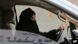 FILE - Aziza al-Yousef drives a car on a highway in Riyadh, Saudi Arabia, as part of a campaign to defy Saudi Arabia's ban on women driving, March 29, 2014. Al-Yousef was one of six activists recently detained in the kingdom, observers said May 18, 2018.