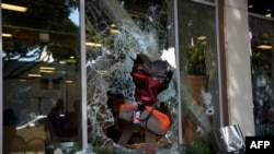FILE - Protesters loot shops in Santa Monica, California, May 31, 2020, during a demonstration over the death of George Floyd in Minneapolis police custody.